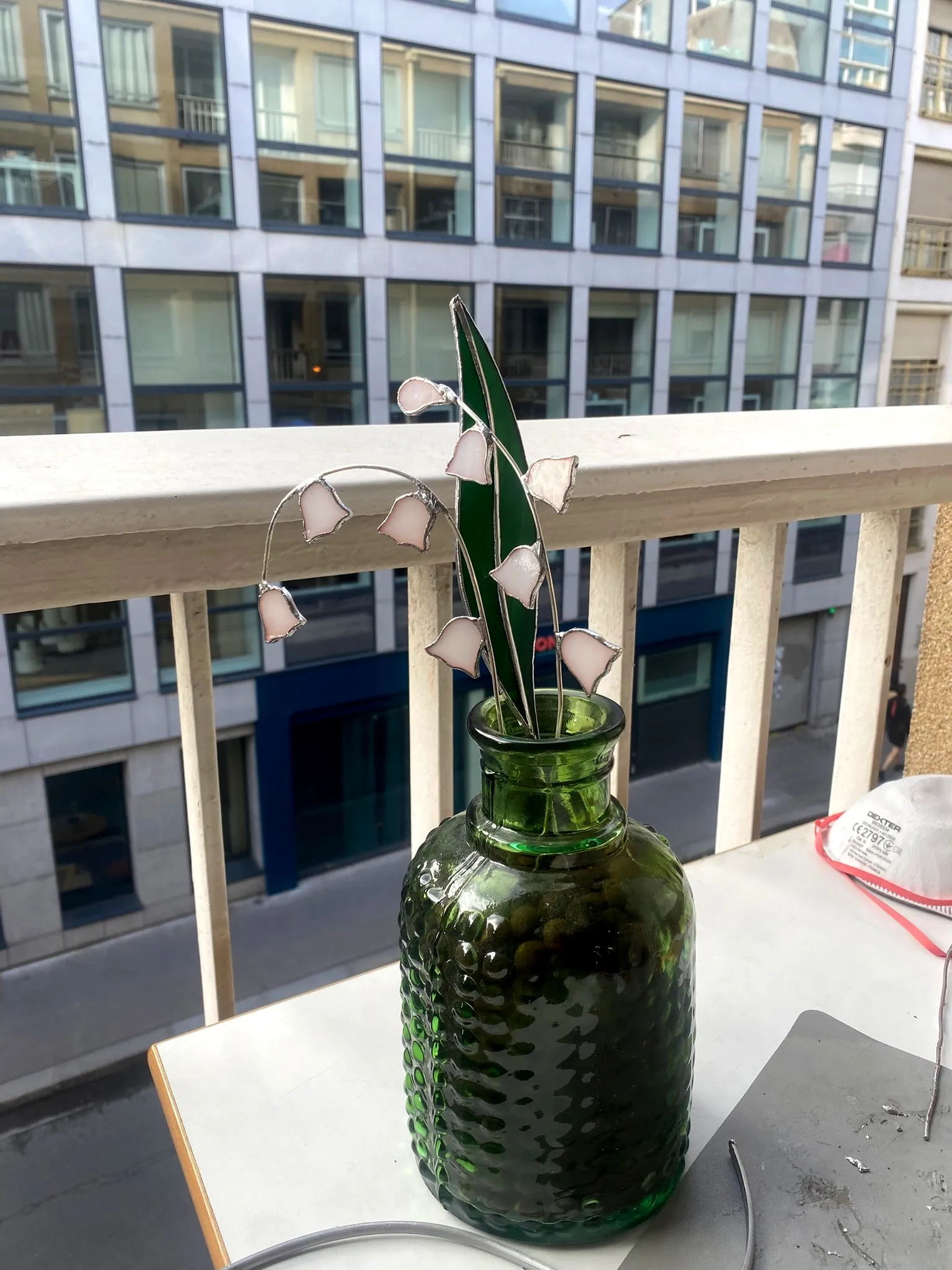 Le muguet en vitrail sur un balcon, en pleine lumière