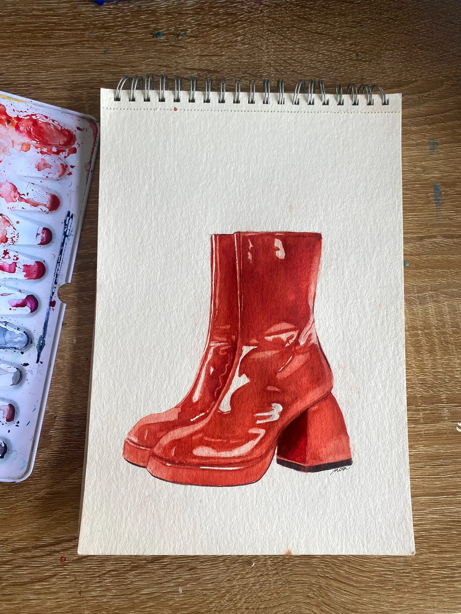 Les bottines rouges peintes, sur le papier