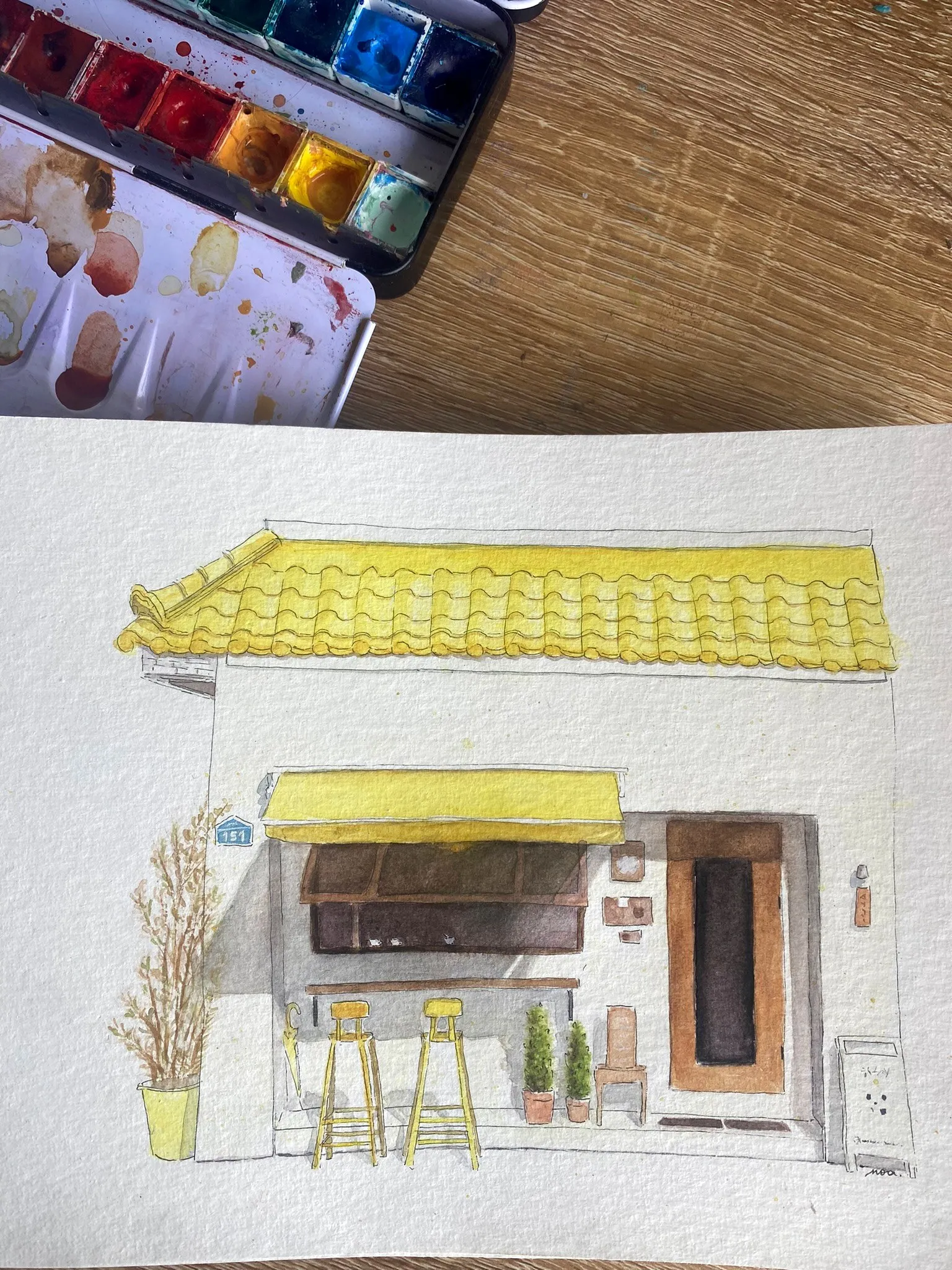 La devanture jaune peinte à l'aquarelle, sur le papier